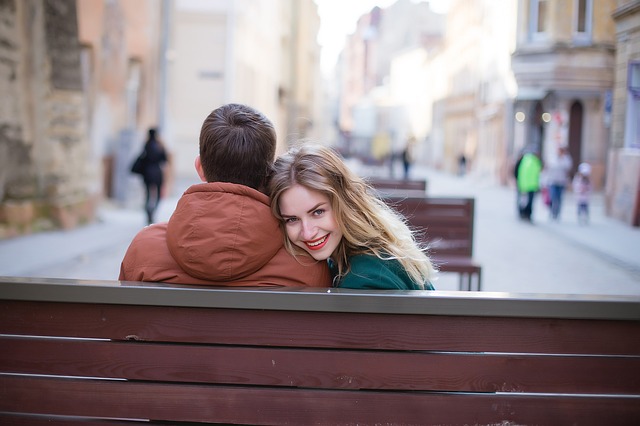 Sweet couple sitting on alley
